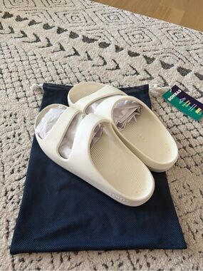 Bombas Cream Slide Sandals with Embossed Logo